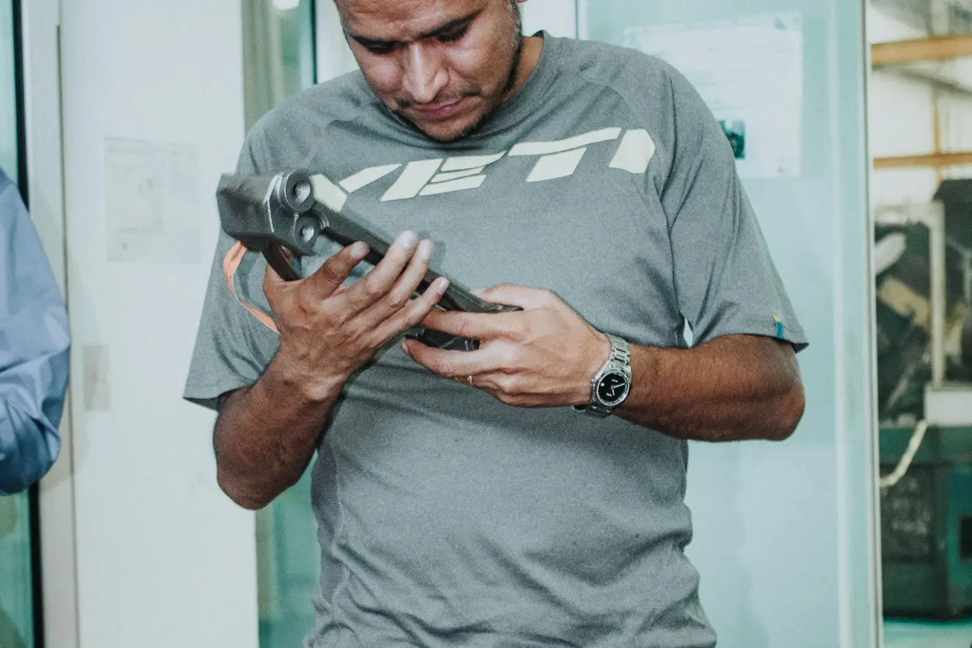 Machinist inspecting a machined aluminum housing in Monterrey