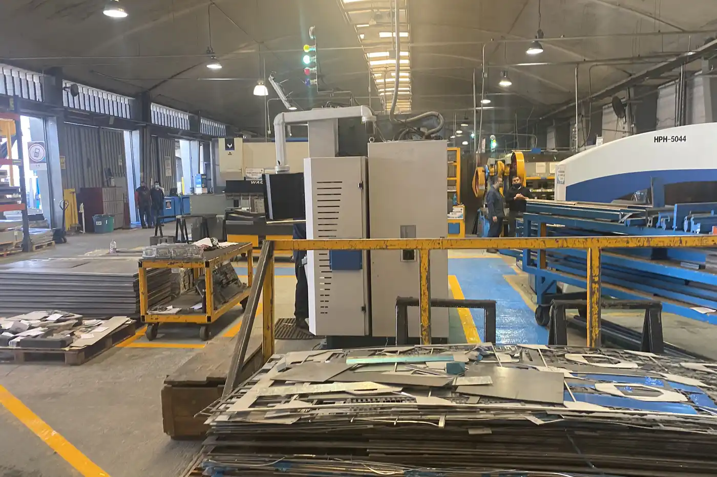 Press brake bay and cut sheet stock in a Monterrey fabrication shop