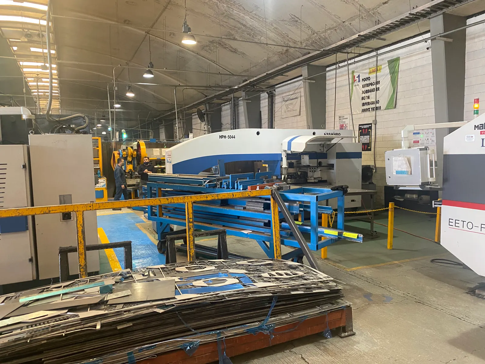 Sheet-metal equipment and cut blanks on a production floor